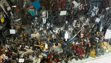 Multiple small action figures, like knights and horses, stuffed next to each other on a surface with multiple levels.